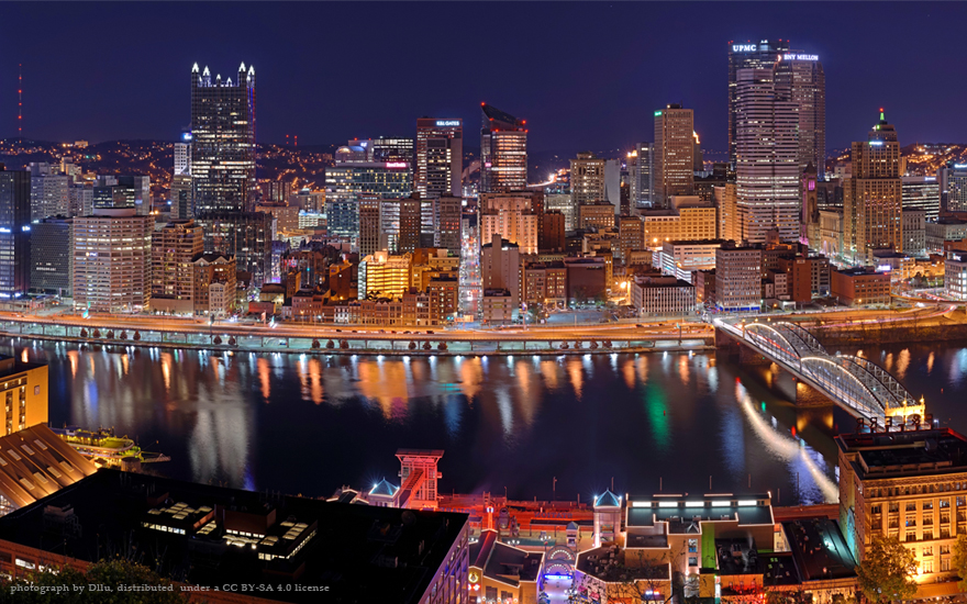 Pittsburgh skyline at night, shown as a case study in The New Localism
